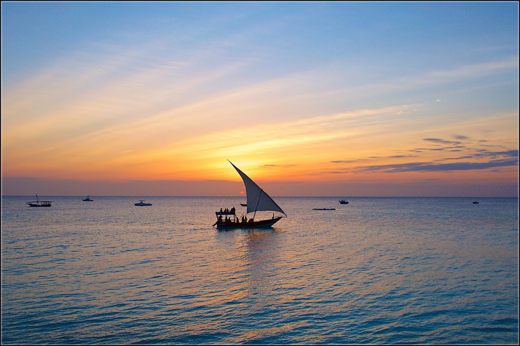 A dhow (sailboat) on the water at sunset in Zanzibar