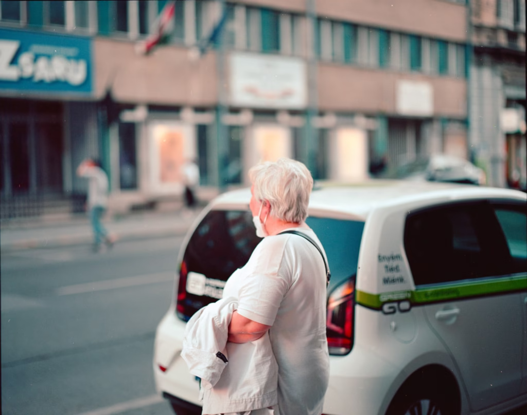 Woman in her 60s waiting confidently for her ride share to arrive