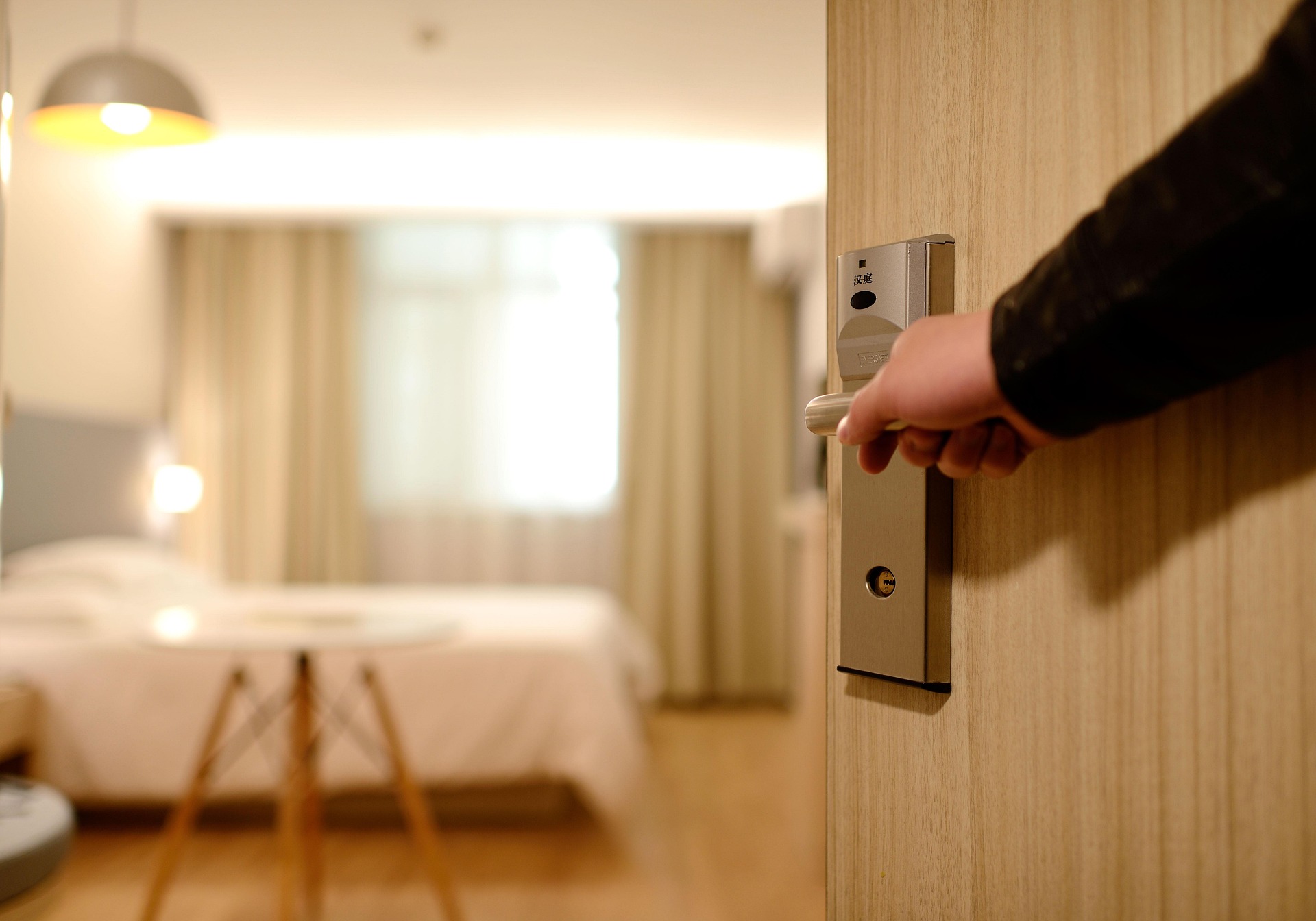 Solo woman checking hotel room security on arrival